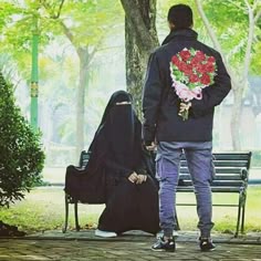 A Muslim husband hiding a flower bouquet behind his back for his wife sitting on a bench in a park.