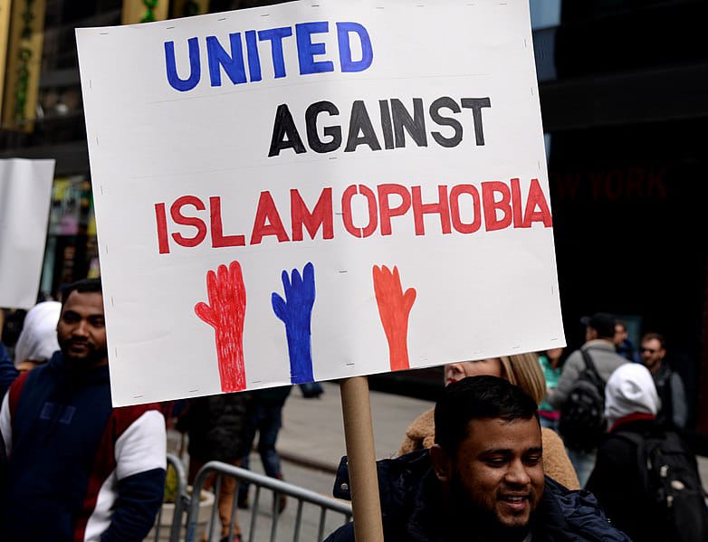 Protesters hold anti-Islamophobia banners during a protest against Islamophobia